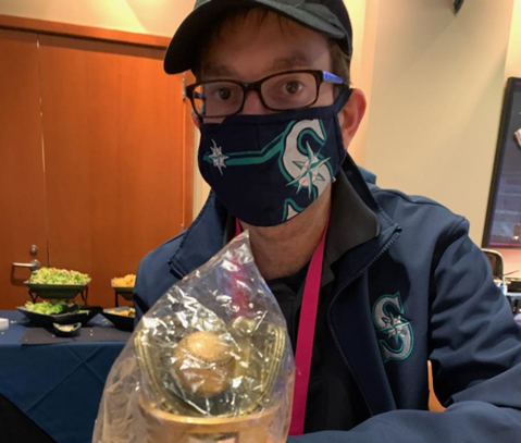 Bert sitting down at a table with a trophy in front of him